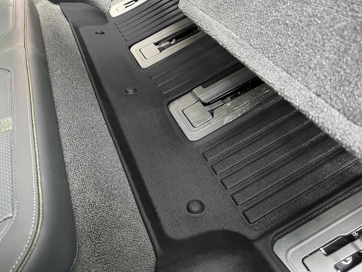 Textured skid-resistant surface of Rivian R1S floor mats